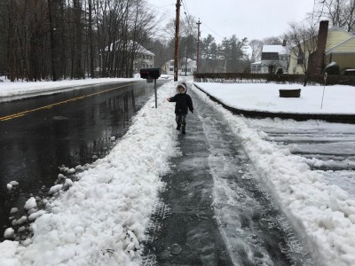 Lijah walking down a slushy/icy sidewalk