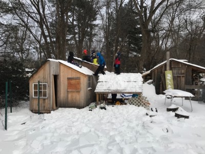 kids climbing on the snowy playhouse and sandbox