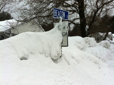 our street sign nearly buried in snow