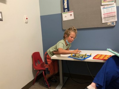 Elijah playing Guess Who at the therapy office