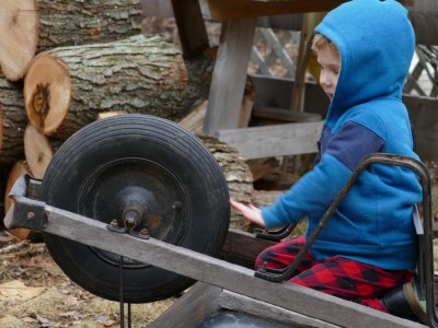 Lijah playing on the wheelbarrow