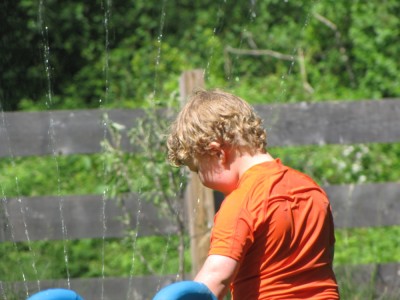 Harvey playing in the sprinkler