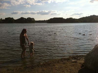 Leah and Lijah wading in the water quietly chasing ducks, at dusk