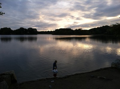 Harvey and Lijah by the shore of Spy Pond at sunset