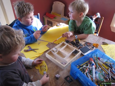 the boys working on crafts at the kitchen table