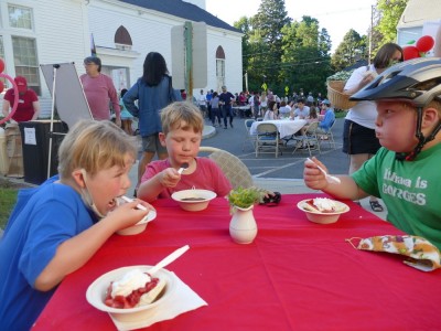 the boys eating shortcake (and chocolate sauce) in a crowded church parking lot