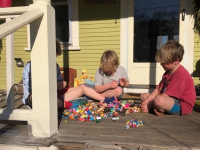Zion, Elijah, and a friend playing with toys on our front porch