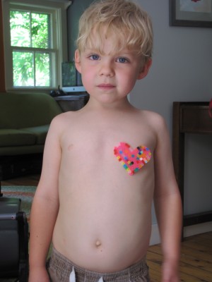 Zion with a perler bead heart sticking to his chest