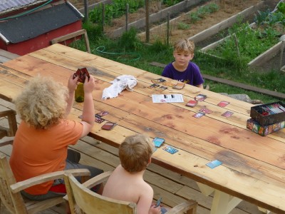 the boys playing a card game on the new picnic table