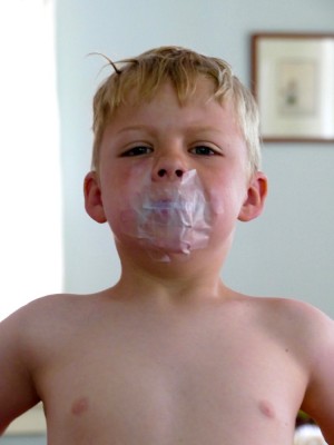 Zion with scotch tape over his mouth