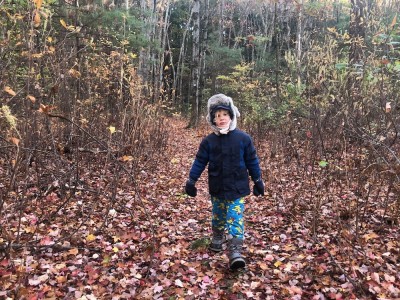 Elijah walking in the woods in winter clothes