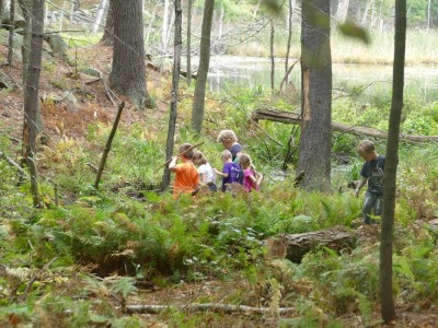 kids playing by a stream
