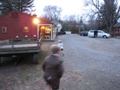 Harvey and Zion running towards the farm store in the dusk