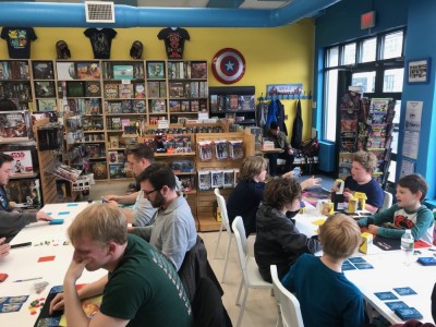 Harvey among the crowd at a comic store playing pokemon