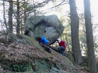 Harvey and Zion climbing up to a giant erratic boulder