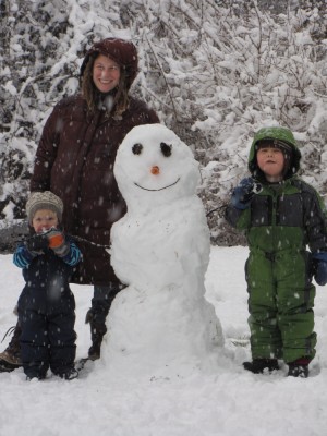family posing with our smiling carrot-nosed snowman