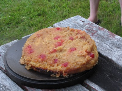 a campfire-cooked pineapple upside-down cake