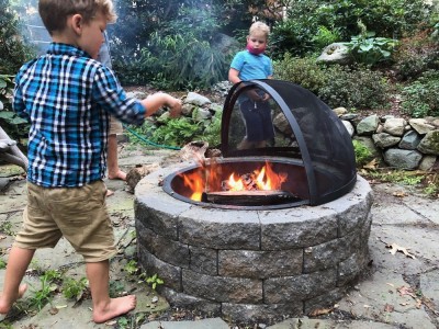 the boys playing with the fire pit at Leah's parents' house