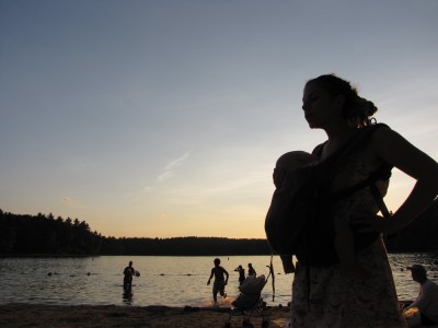 Leah, with Lijah in the ergo, by the pond in the setting sun