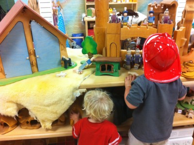 the boys looking at hand-made wooden toys