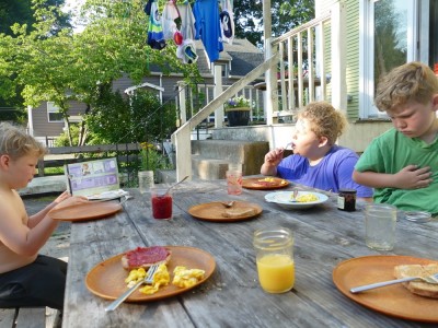 the boys eating breakfast at the picnic table