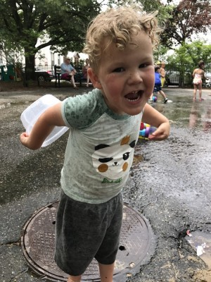 Lijah making a silly face at a spray park