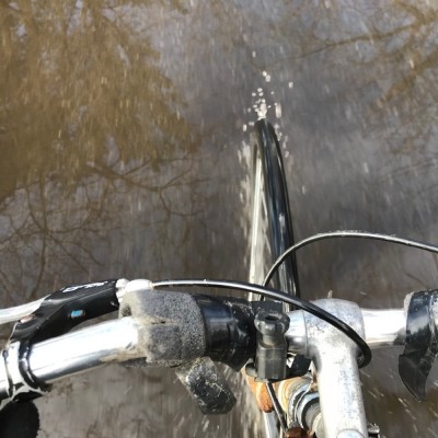 a view of my front wheel cycling through a giant puddle