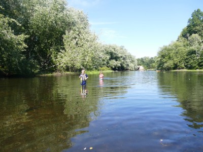 Zion and Elijah wading in the middle of the Concord River
