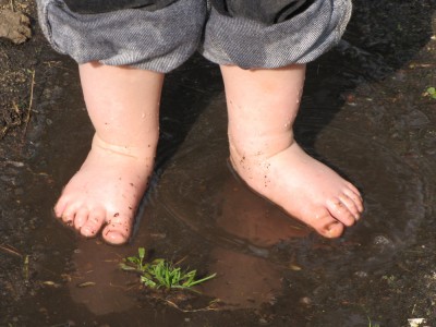 Harvey's bare feet in a puddle