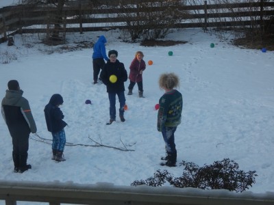 kids playing dodgeball in our snowy yard