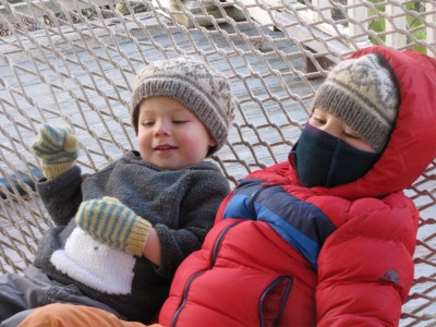 Harvey and Zion in winter gear on the hammock