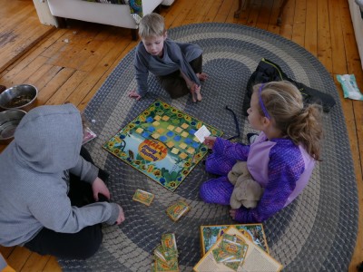 Harvey, Zion, and Havana playing a board game