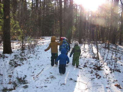 Harvey, Zion, and friends, in full winter gear, walking in the woods