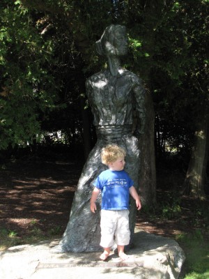 Harvey posing with a statue of Edna St. Vincent Millay