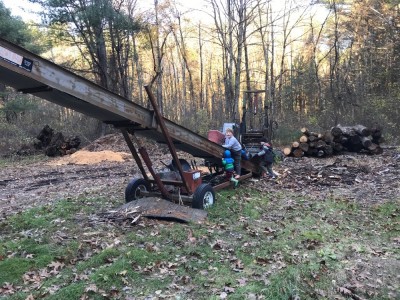 the boys checking out a big rusty machine on a hike