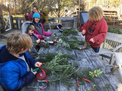 the boys and friends making wreaths on the back deck