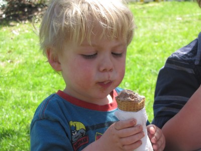 Zion concentrating on his chocolate ice-cream cone