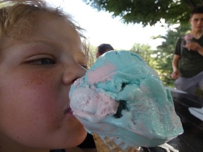 Zion eating a giant blue-and-pink ice cream cone