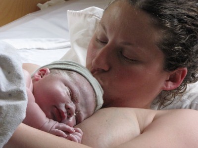 Mama kissing the newborn baby